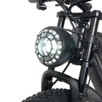 Close-up of a motorcycle headlight on a white background