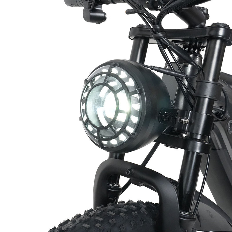 Close-up of a motorcycle headlight on a white background